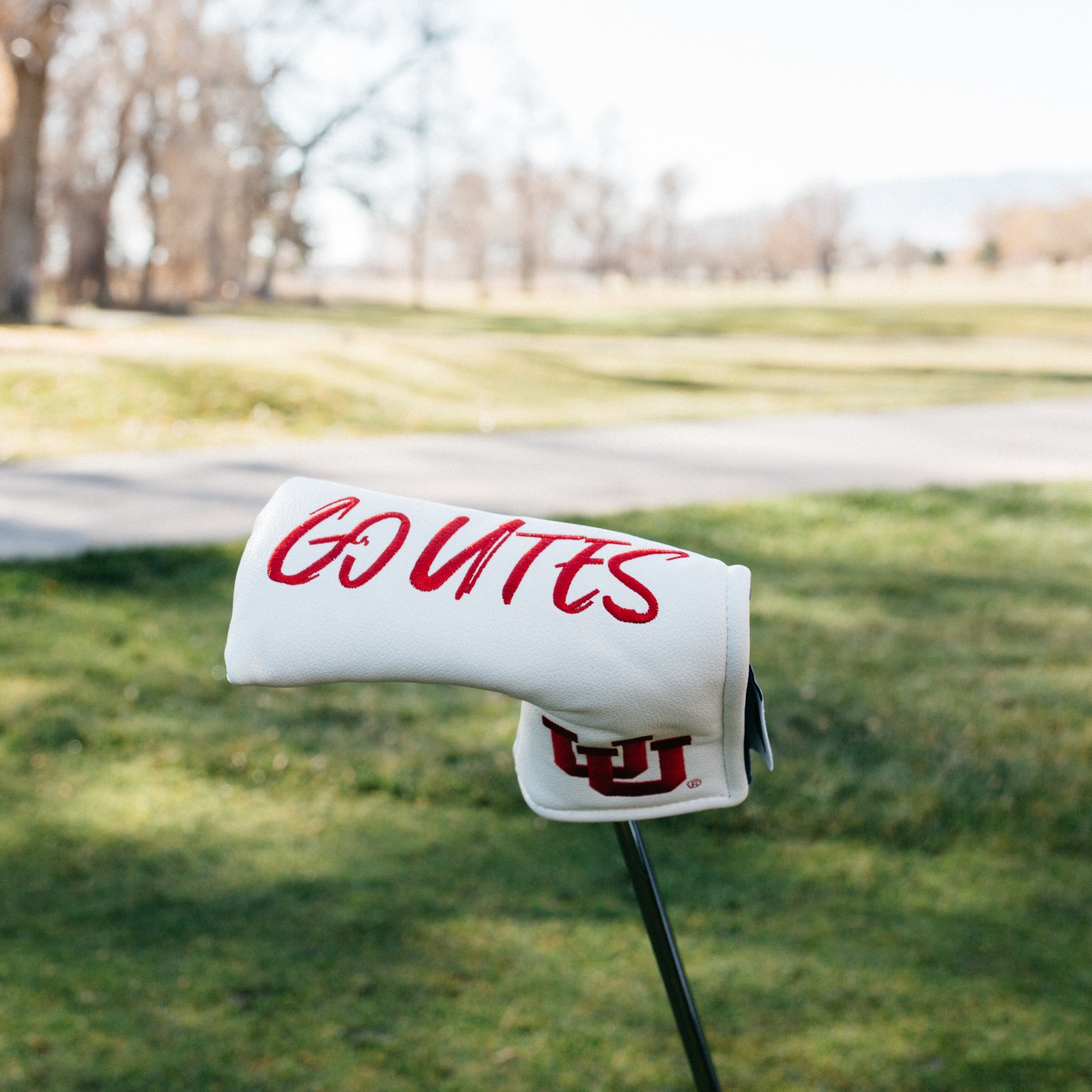 Golf Headcoverwith 'GO UTES' and a logo on a grassy area